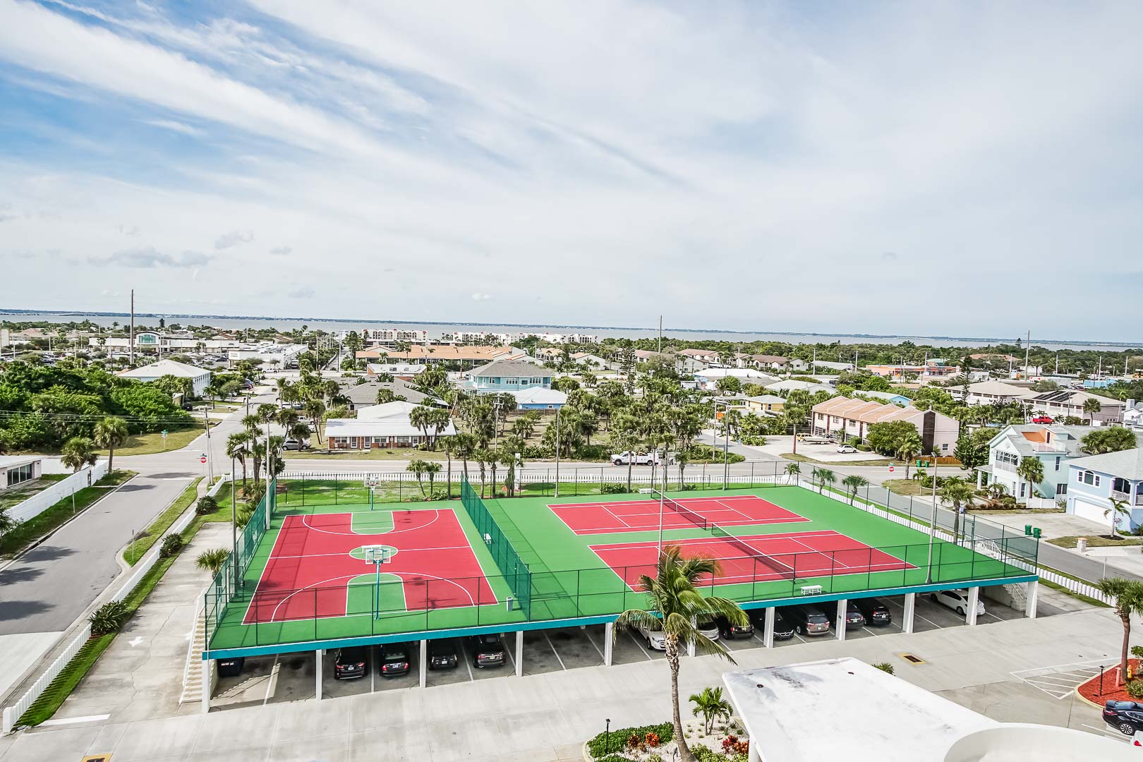 An expansive view of the tennis court and basketball court at VRI's Discovery Beach Resort in Cocoa Beach, Florida.